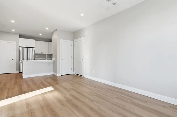 a view of a kitchen with wooden floor and a sink