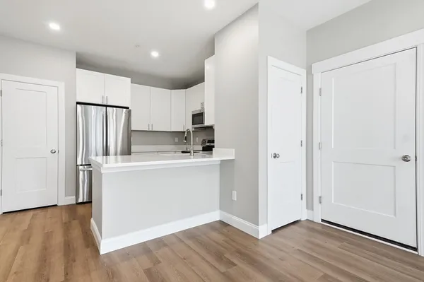 a kitchen with stainless steel appliances a refrigerator and a stove top oven