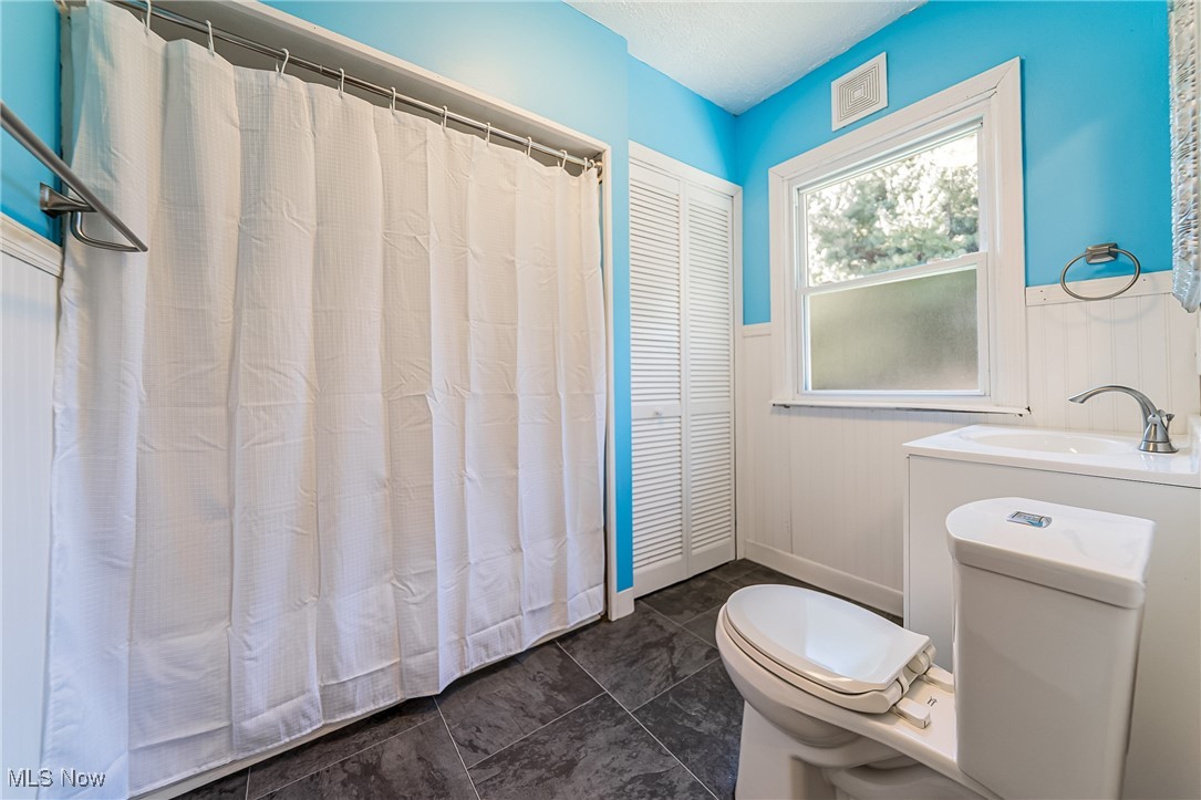 33384 Chestnut Ridge Road North Ridgeville, OH 44039 - Photo 15 of 30 Bathroom with a wainscoted wall, a closet, and a shower with curtain