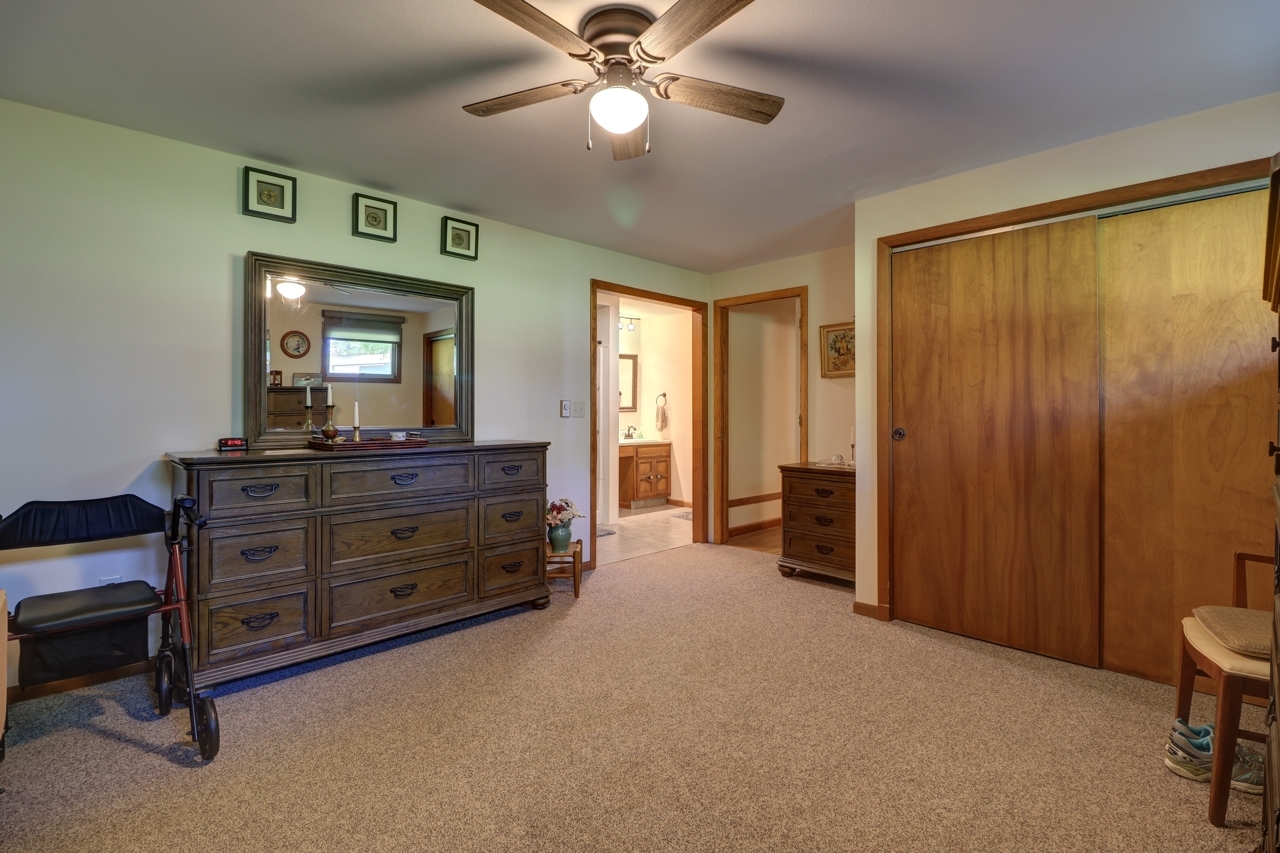 14755 Fenton Road Morrison, IL 61270 - Photo 14 of 34 a room with a bed and a mirror on dresser