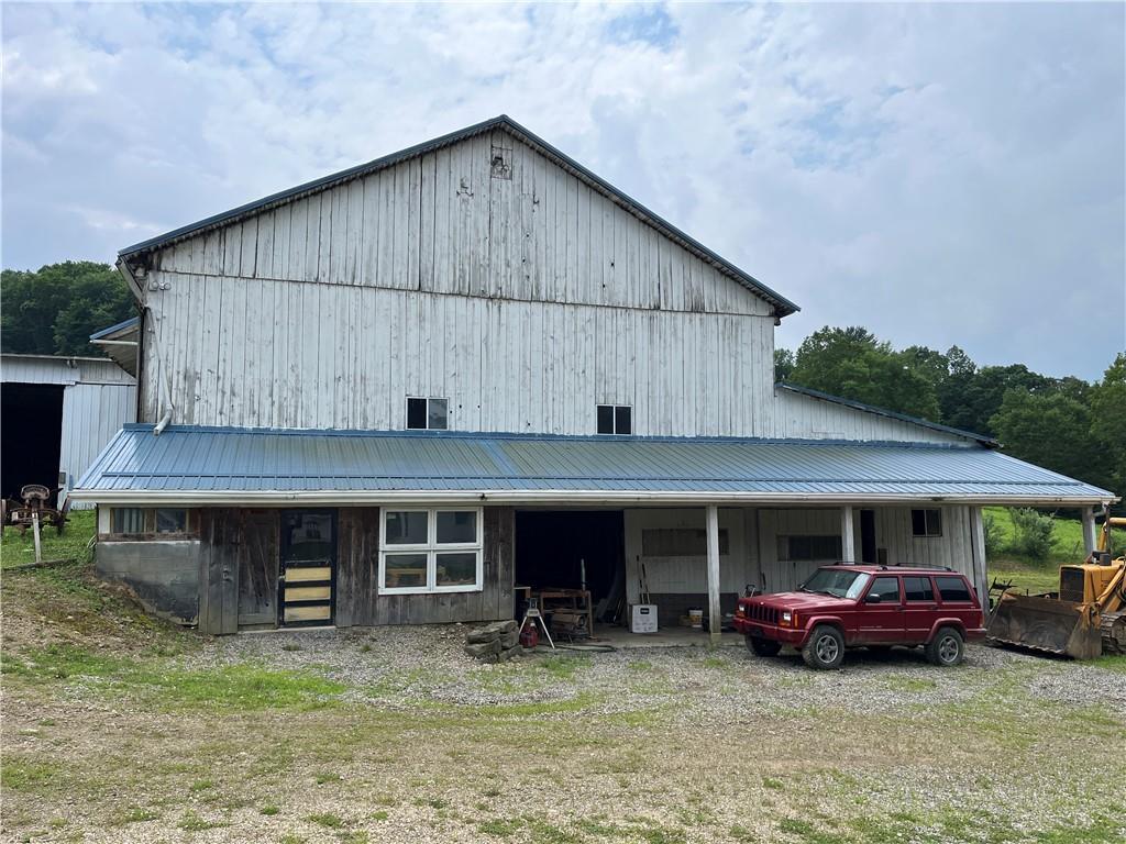 83 Seger Road Punxsutawney, PA 15767 - Photo 21 of 24 a view of a house with a barbeque and large trees