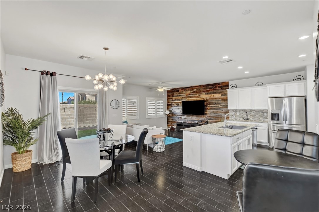 48 Jasmine Point Street Henderson, NV 89074 - Photo 61 of 62 An open floorplan seamlessly connects the well-appointed kitchen to a inviting dining area and comfortable living space.