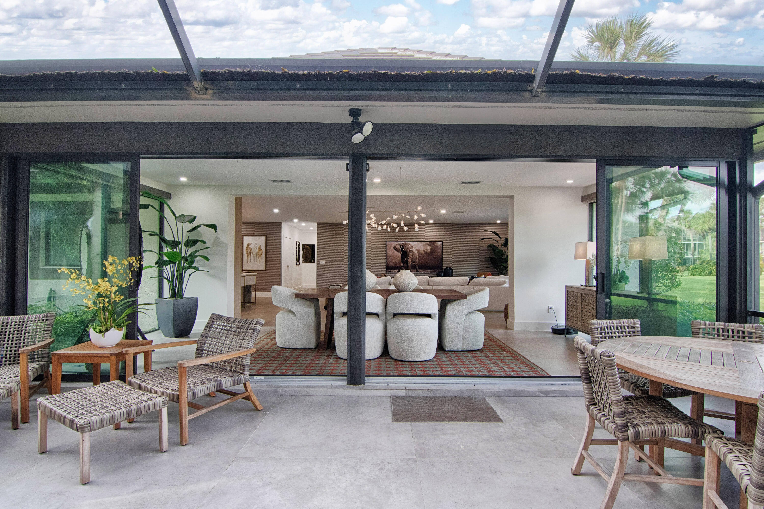 13244 Polo Club Road, Unit C105 Wellington, FL 33414 - Photo 17 of 42 a living room with patio furniture and a potted plant