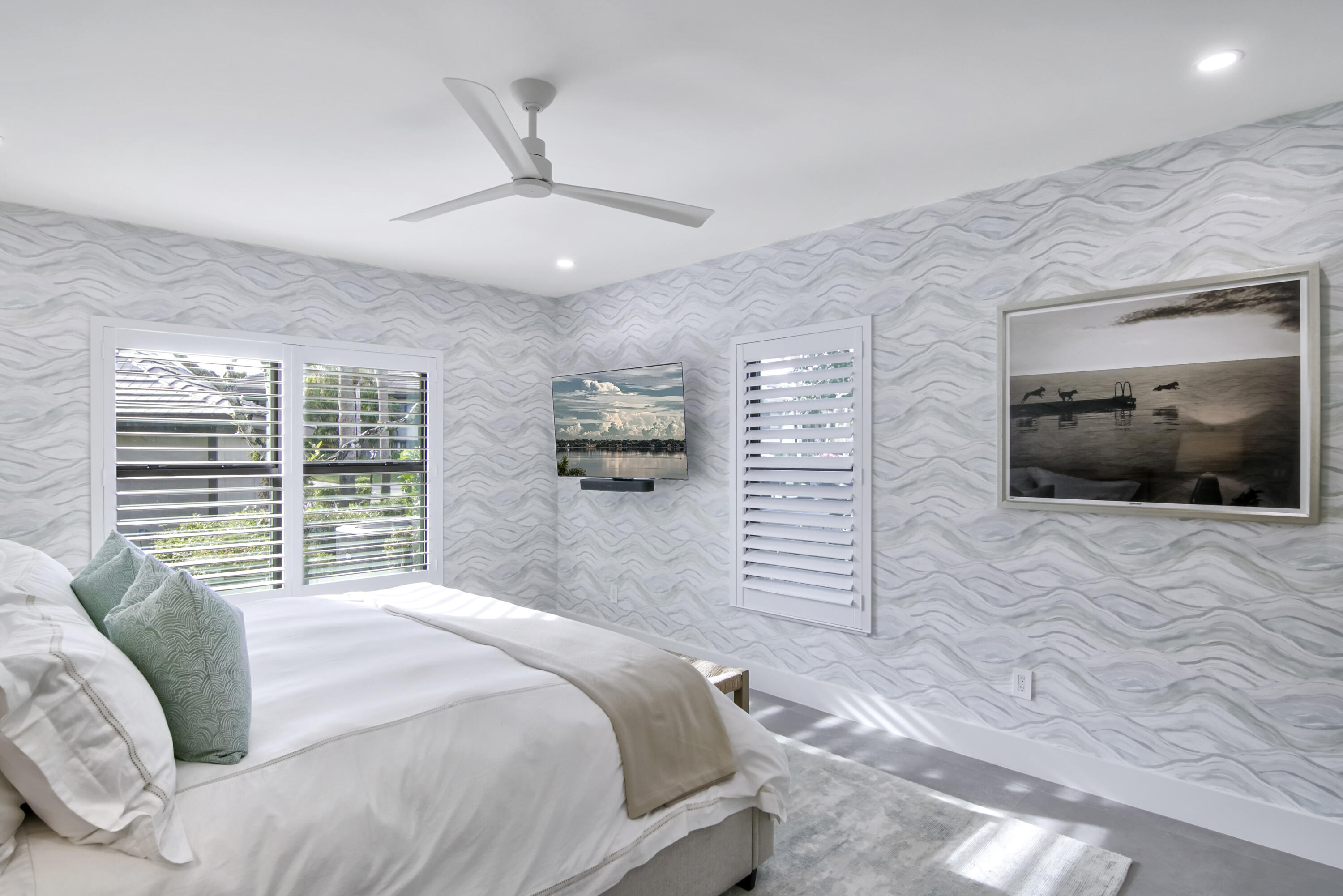 13244 Polo Club Road, Unit C105 Wellington, FL 33414 - Photo 32 of 42 a bedroom with a large bed and a flat screen tv