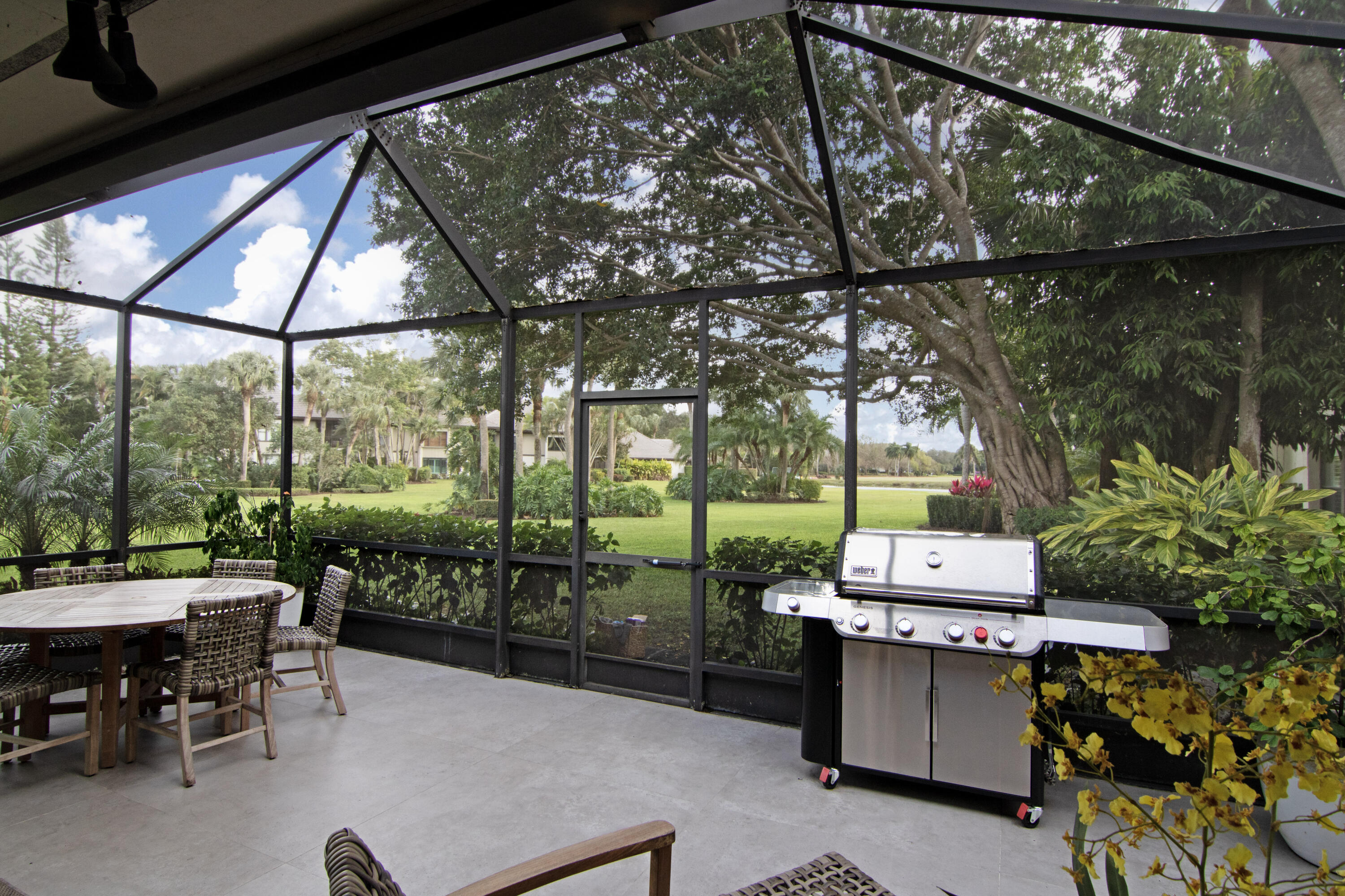 13244 Polo Club Road, Unit C105 Wellington, FL 33414 - Photo 39 of 42 a patio with yard glass top table and chairs