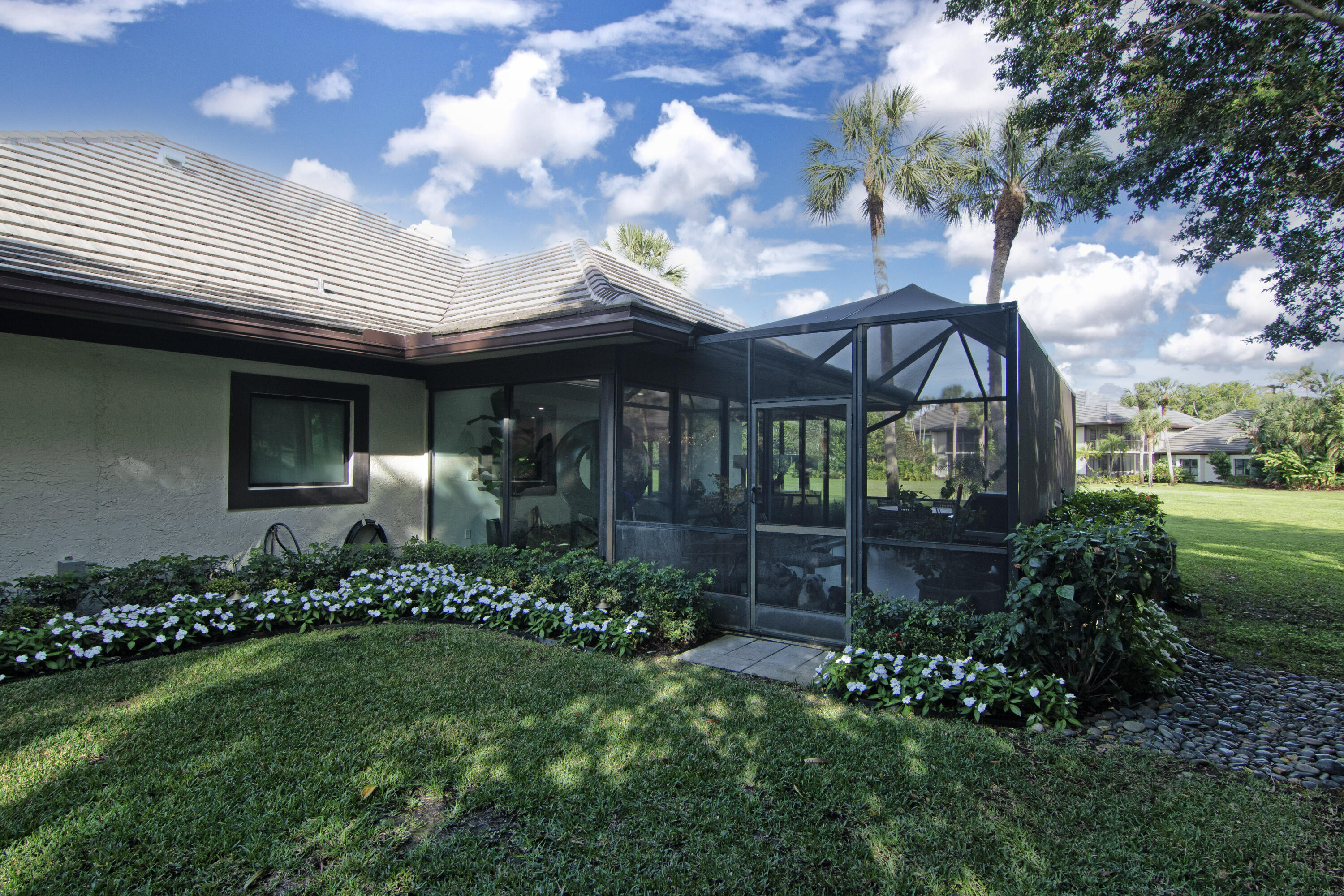 13244 Polo Club Road, Unit C105 Wellington, FL 33414 - Photo 40 of 42 a front view of house with a garden
