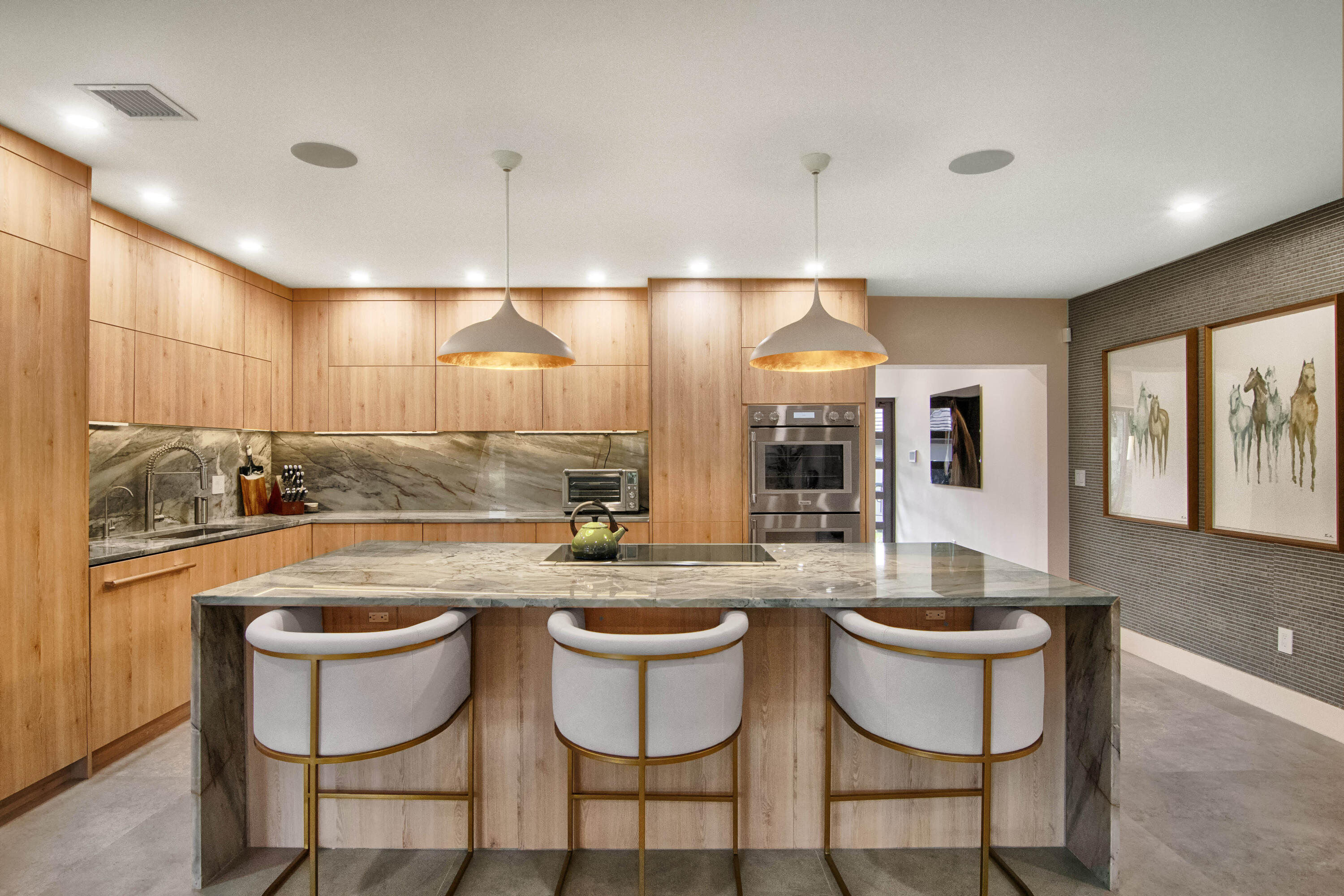 13244 Polo Club Road, Unit C105 Wellington, FL 33414 - Photo 10 of 42 a dining hall with stainless steel appliances kitchen island a table and chairs
