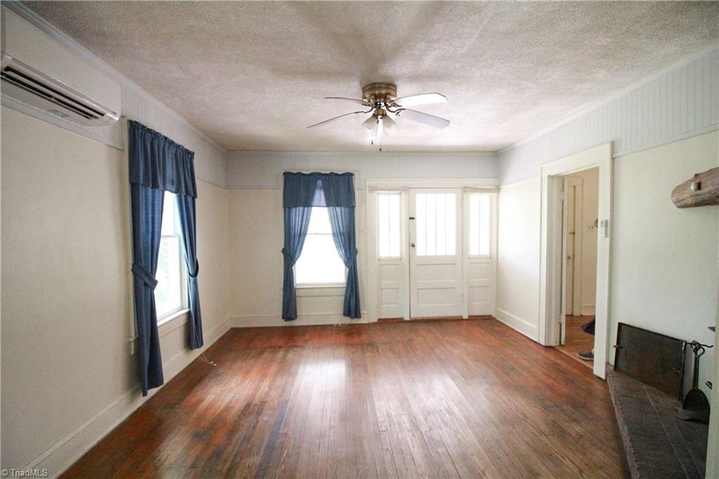2067 Riverside Circle Eden, NC 27288 - Photo 30 of 50 Living room with original hardwood floors and fireplace.