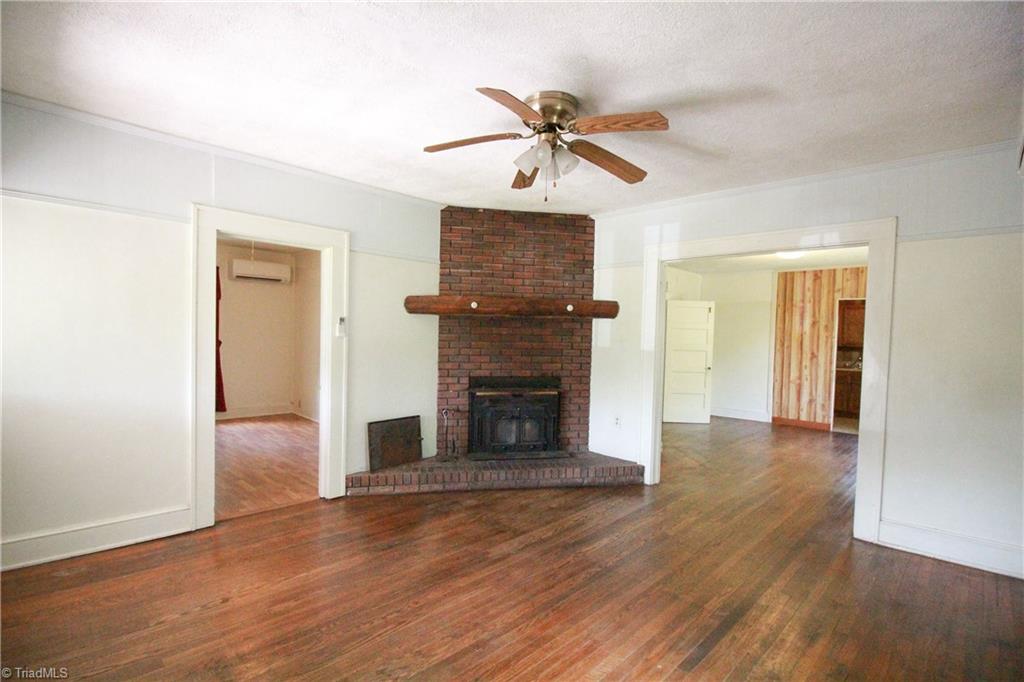 2067 Riverside Circle Eden, NC 27288 - Photo 33 of 50 Living room fireplace wood insert, open to dining room and front bedroom