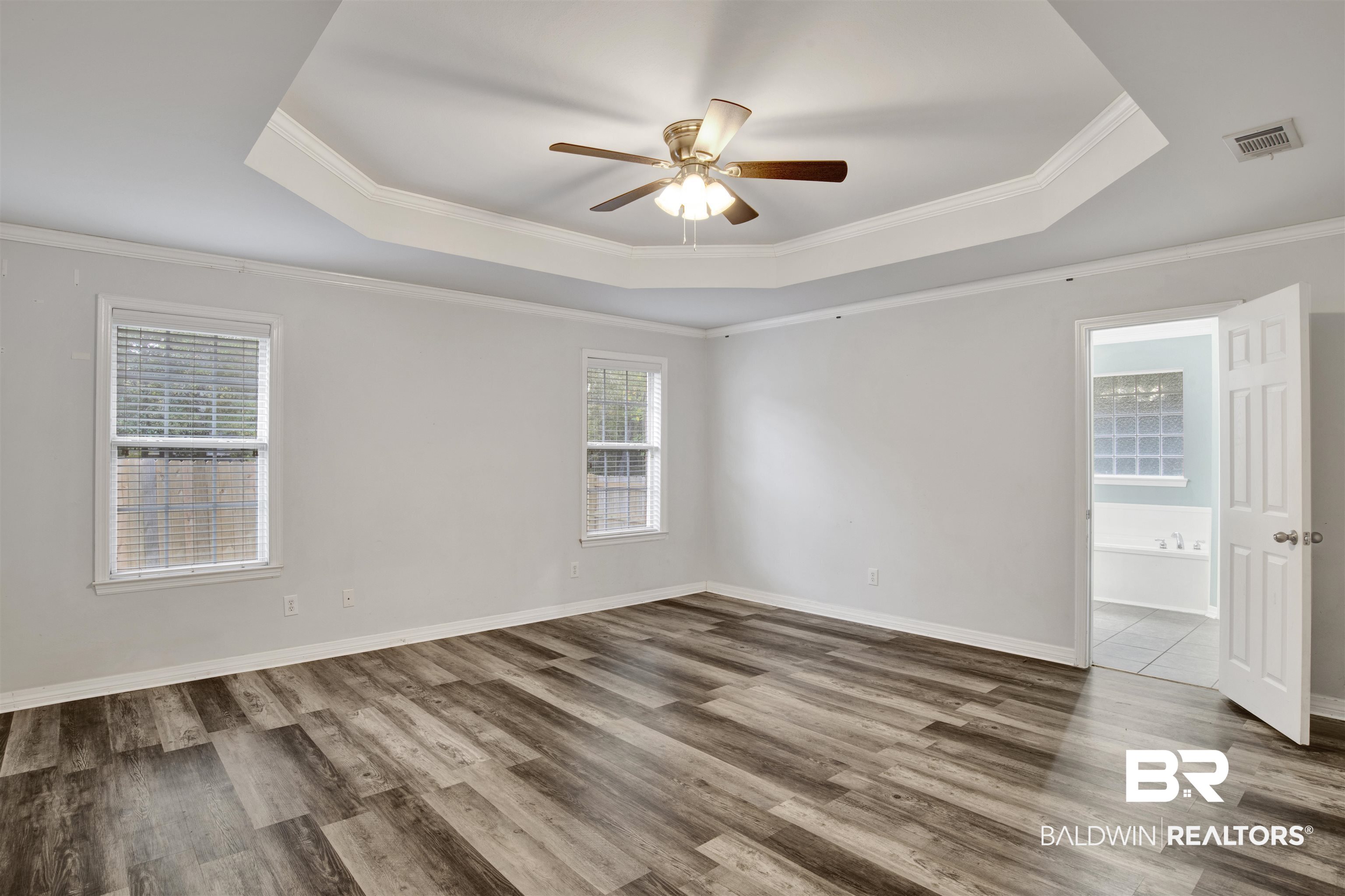 9534 Labrador Run North Mobile, AL 36695 - Photo 22 of 30 Spare room featuring a tray ceiling, ornamental molding, wood finished floors, and ceiling fan