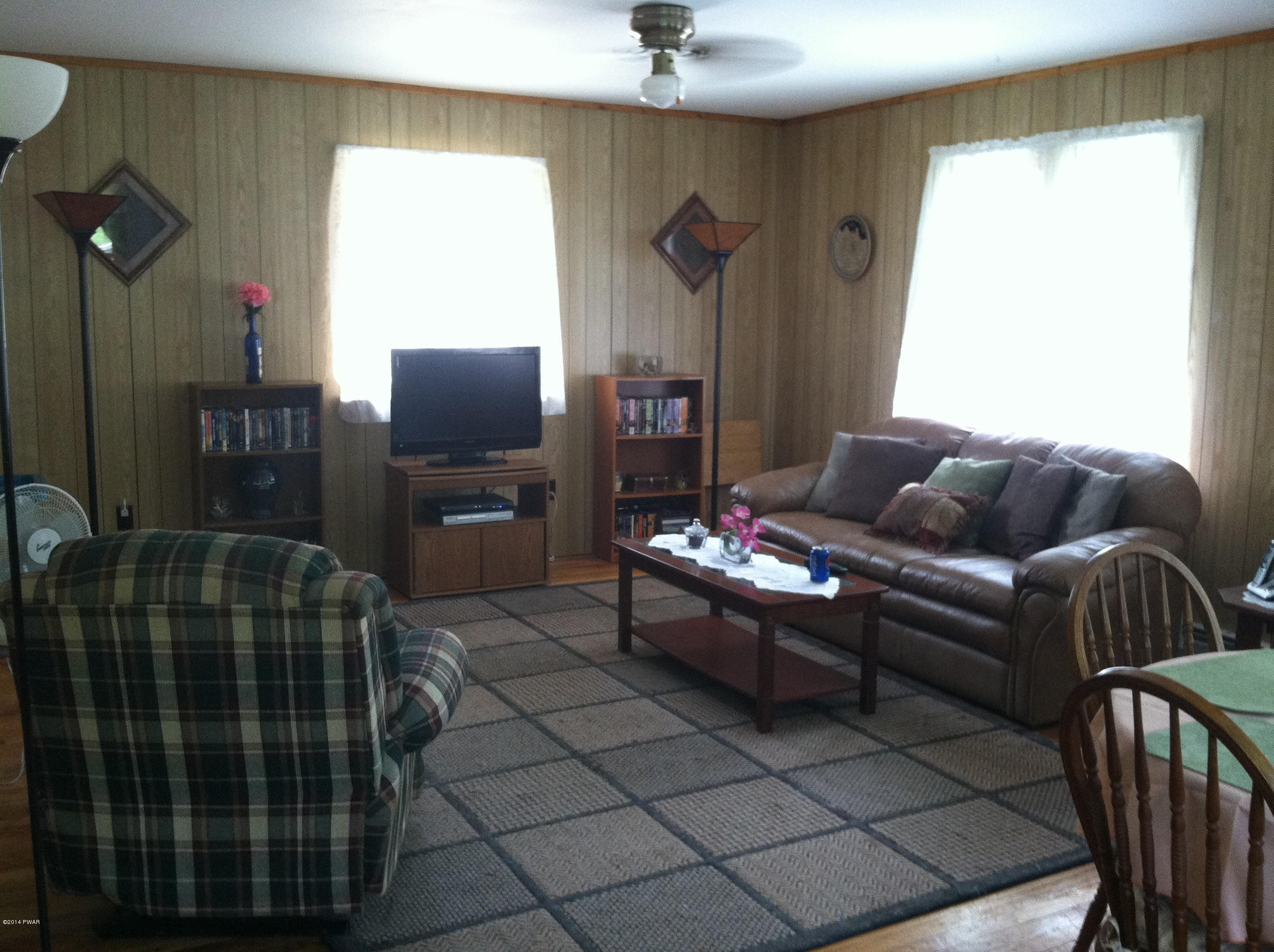 85 Elk Brook Road Road Delhi, NY 13753 - Photo 10 of 11 a living room with furniture and a flat screen tv