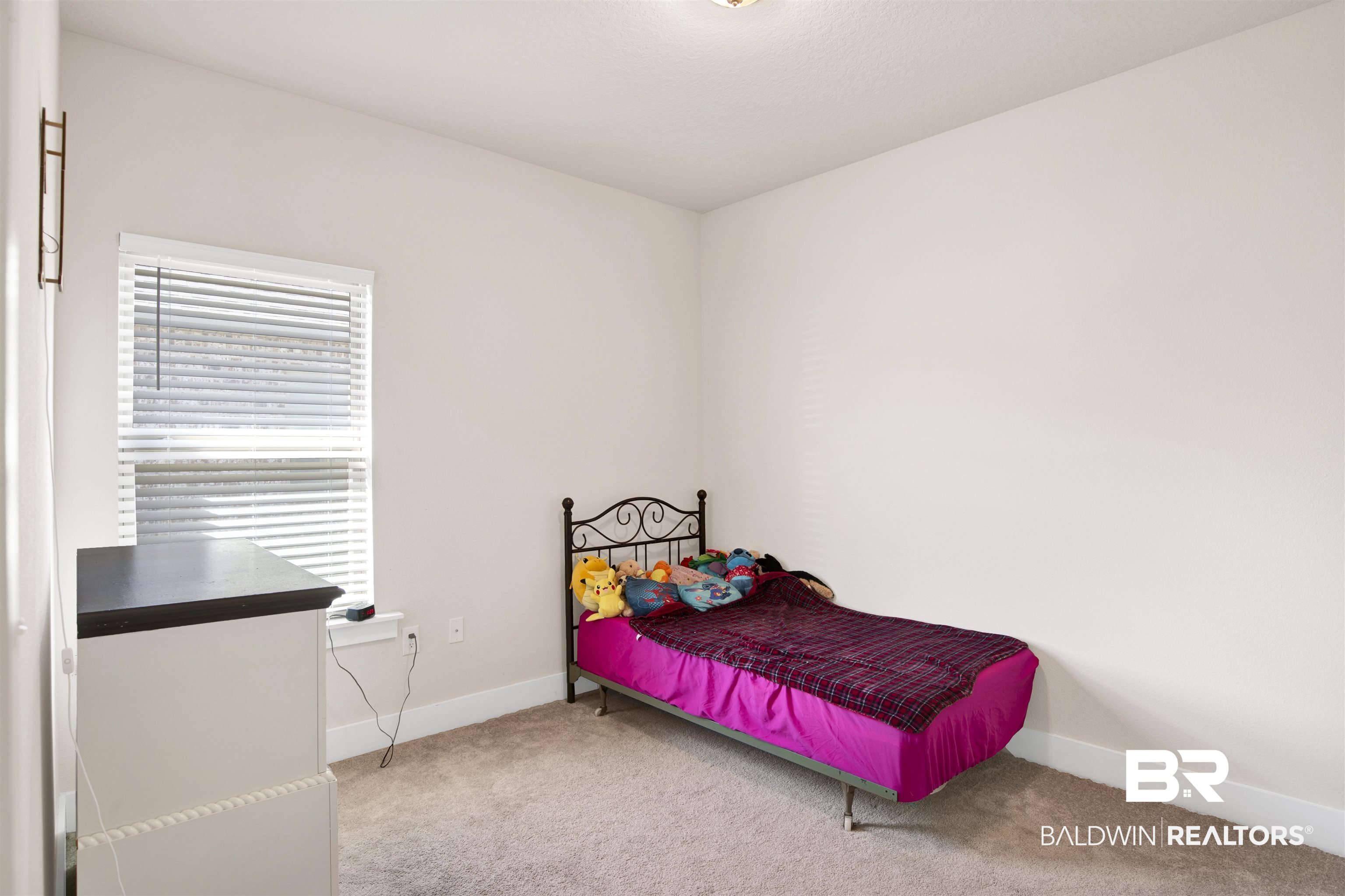 1174 Pheasant Circle Foley, AL 36535 - Photo 16 of 29 Bedroom with light colored carpet and baseboards