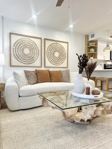 a living room with furniture and painting on the wall