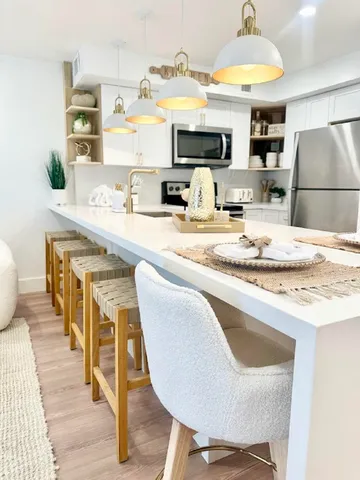 a kitchen with kitchen island granite countertop a sink and a stove