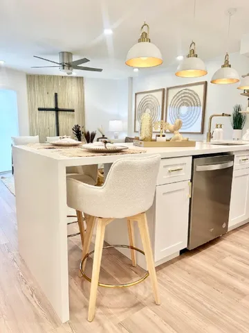 a kitchen with a sink cabinets and window