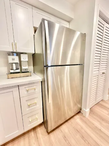 a white refrigerator freezer sitting inside of a kitchen