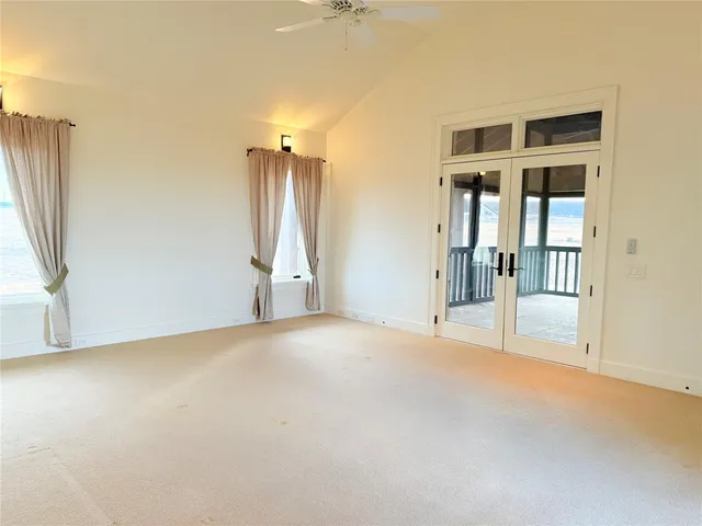 a view of empty room with floor to ceiling window