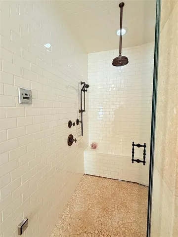 a view of an empty room with a window and cabinet