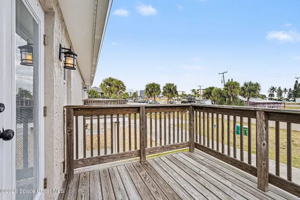 a view of a balcony with wooden floor