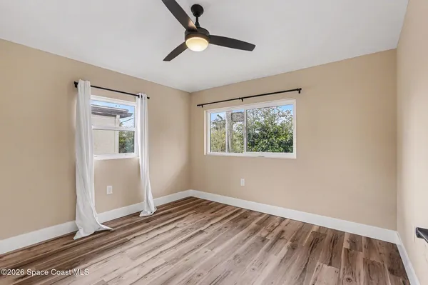 wooden floor in an empty room with a window