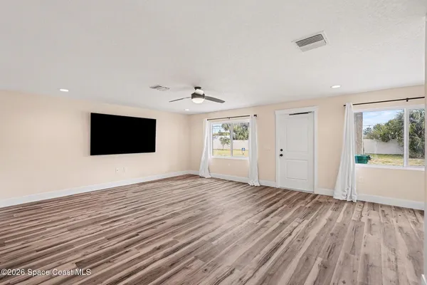 wooden floor in an empty room with a window