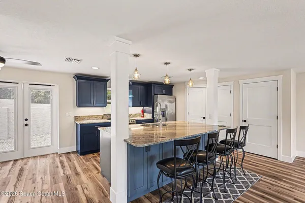 a kitchen with stainless steel appliances kitchen island granite countertop a sink and cabinets
