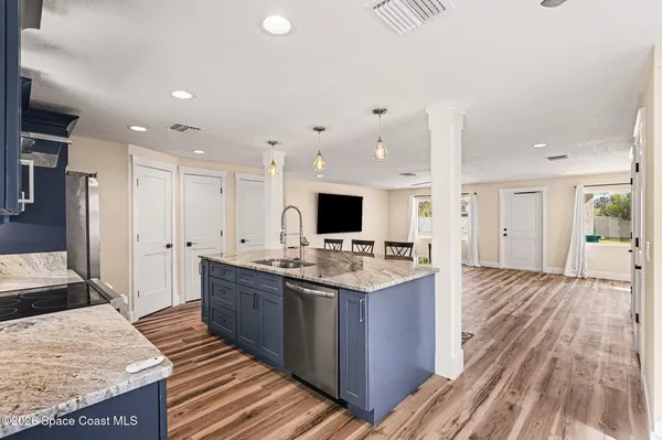 a kitchen with stainless steel appliances granite countertop a stove and a refrigerator