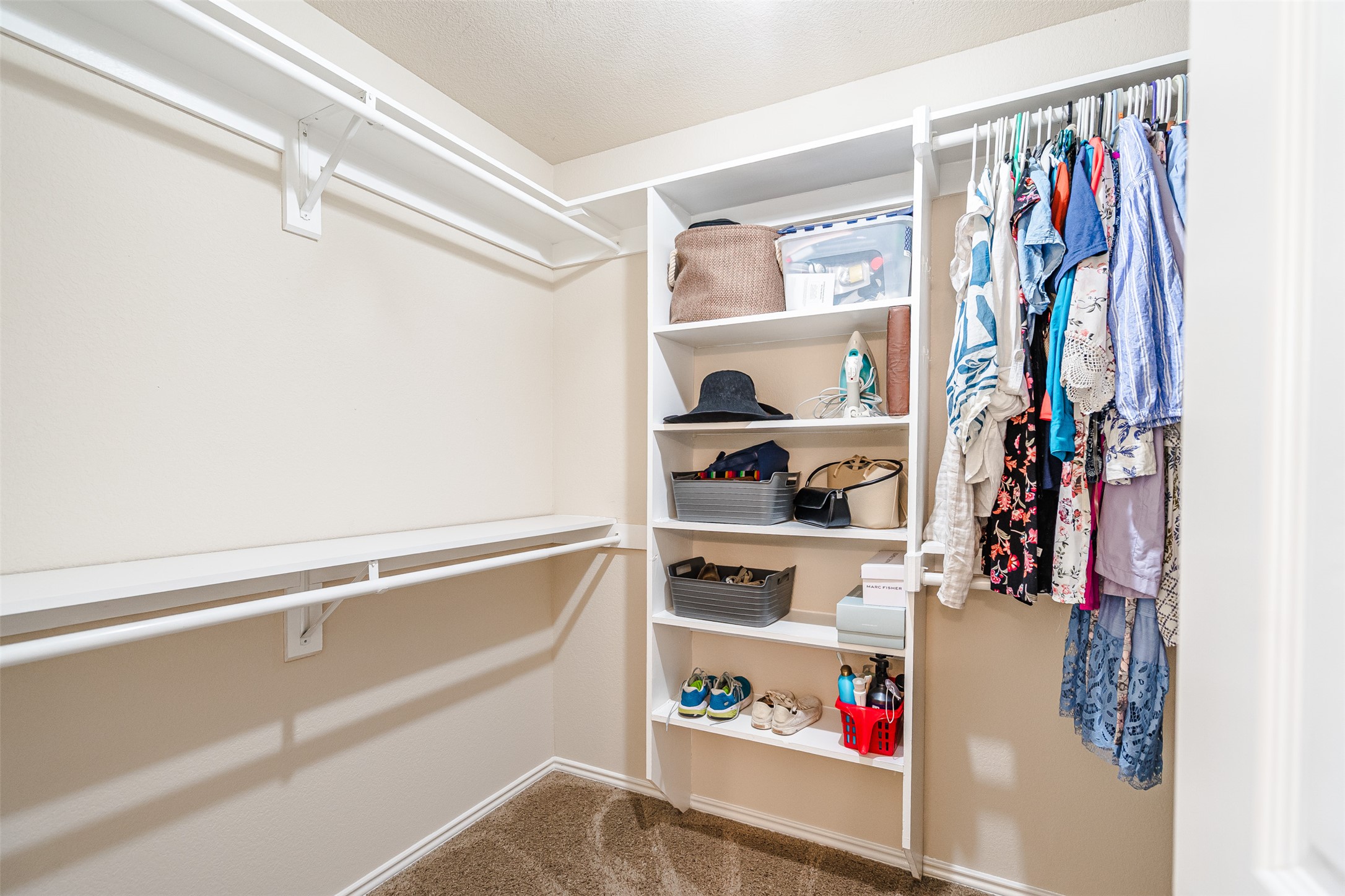 2404 Christoff Loop Austin, TX 78748 - Photo 14 of 24 a view of walk in closet with clothes and shoes