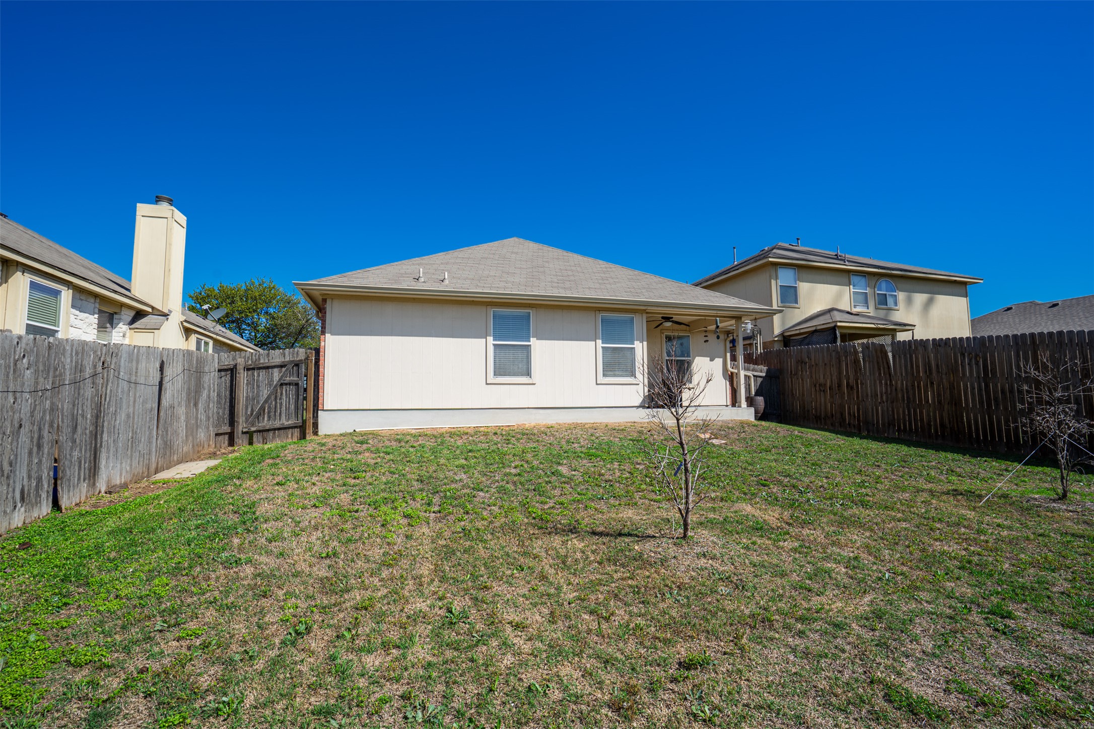 2404 Christoff Loop Austin, TX 78748 - Photo 18 of 24 a view of a house with a yard and wooden fence