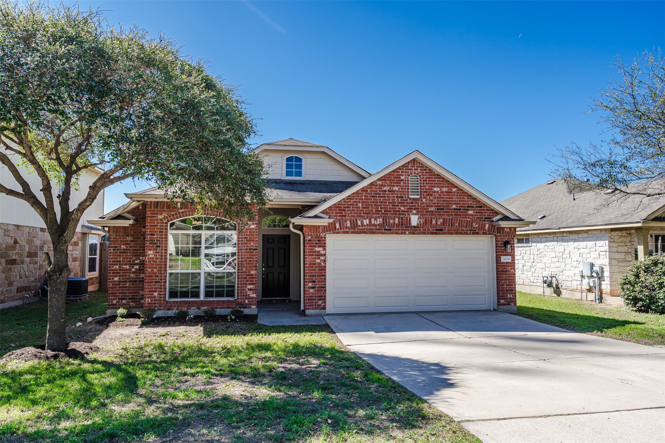 2404 Christoff Loop Austin, TX 78748 - Photo 5 of 24 a front view of a house with a yard and garage