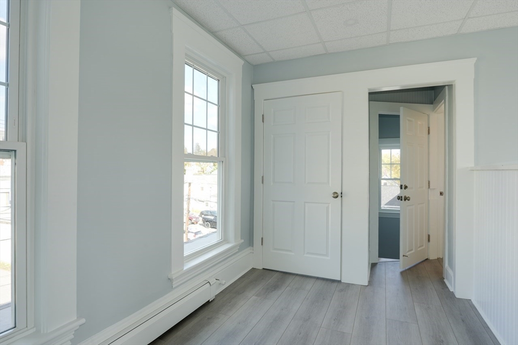 47 Mechanic Street, Unit 2 Marlborough, MA 01752 - Photo 11 of 26 a view of an empty room with wooden floor and a window