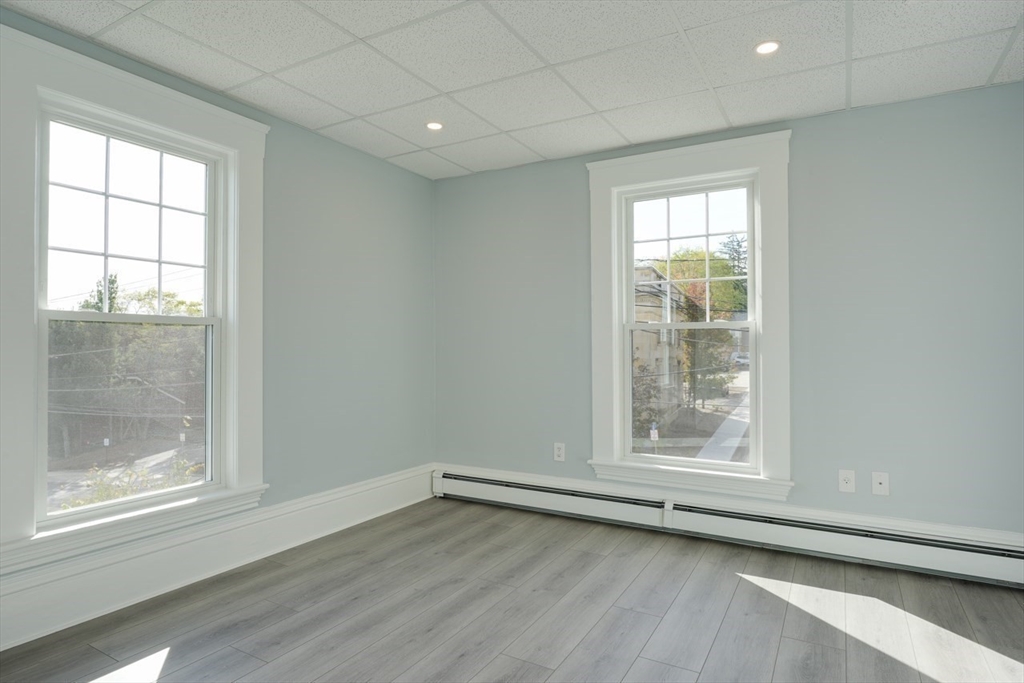 47 Mechanic Street, Unit 2 Marlborough, MA 01752 - Photo 16 of 26 an empty room with wooden floor and windows