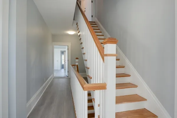 a view of entryway and hall with wooden floor