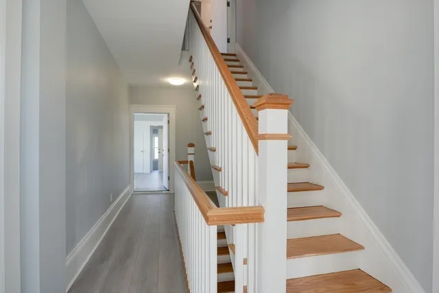 a view of entryway and hall with wooden floor