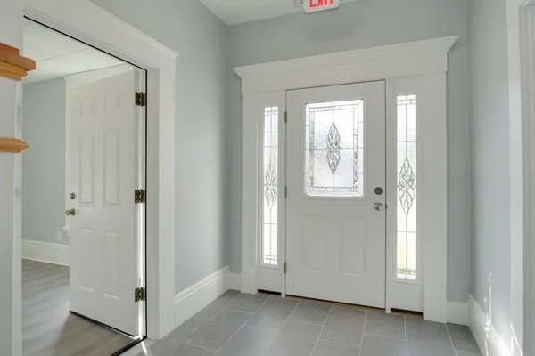 a view of an entryway with wooden floor