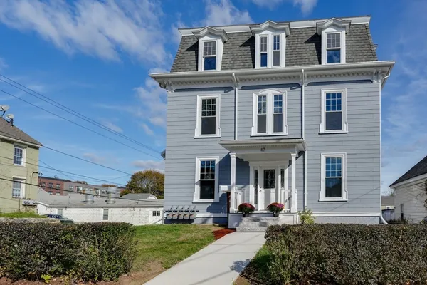 a front view of a house with a garden