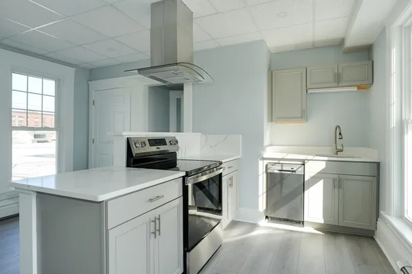 a kitchen with a sink cabinets and stainless steel appliances