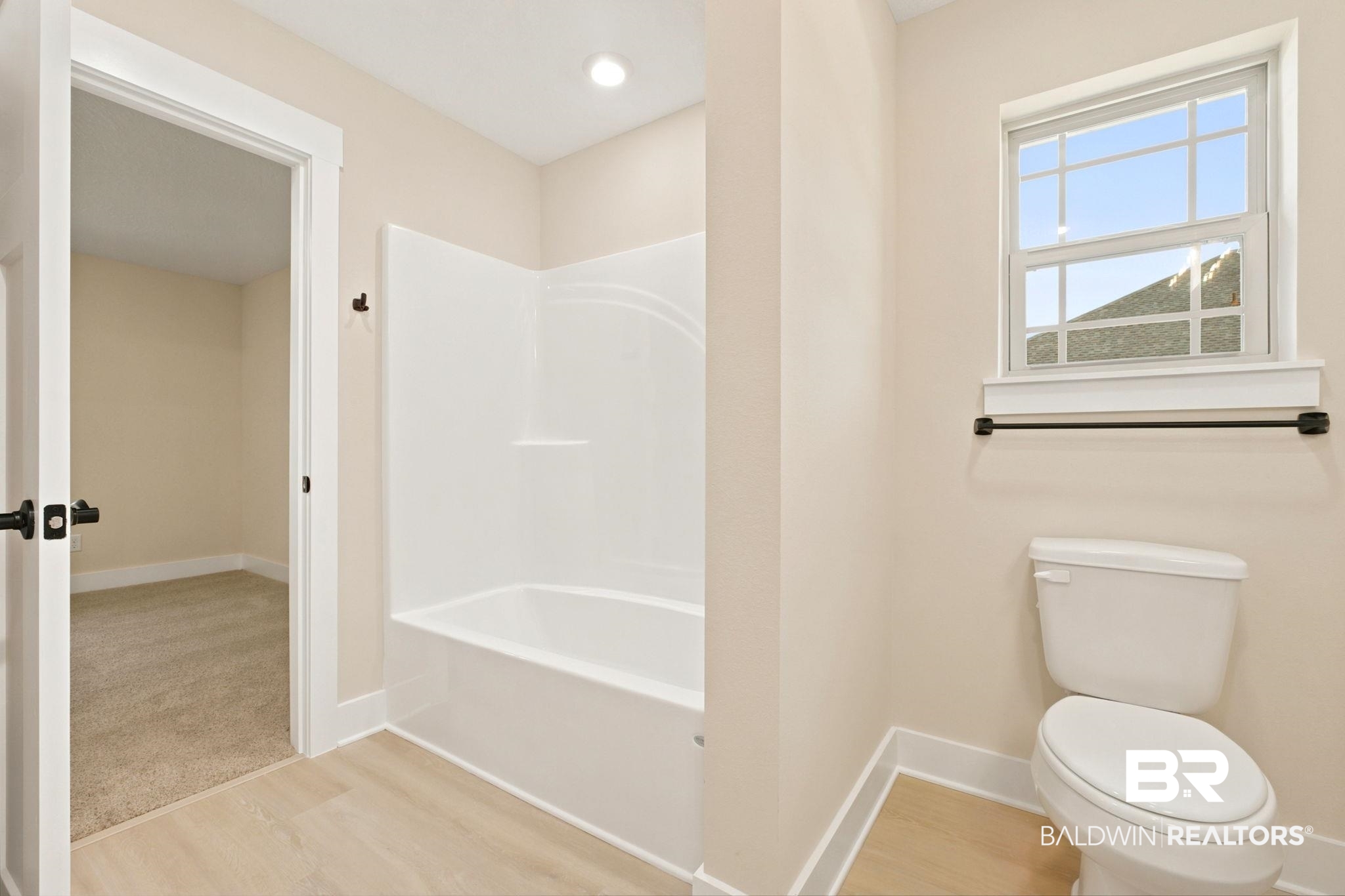 32656 Arbor Ridge Circle Lillian, AL 36549 - Photo 25 of 56 Full bathroom featuring a white tub/shower combination, light wood-finish flooring, a window above the toilet, and a recessed ceiling light