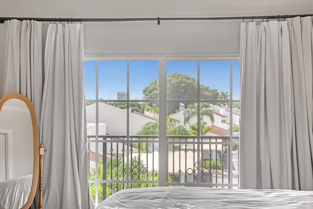 a view of a balcony with wooden floor and door
