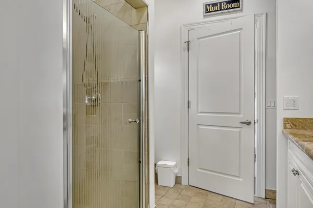 a bathroom with a shower a toilet and a sink