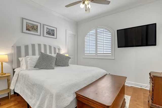 a bed room with a bed window and a flat screen tv