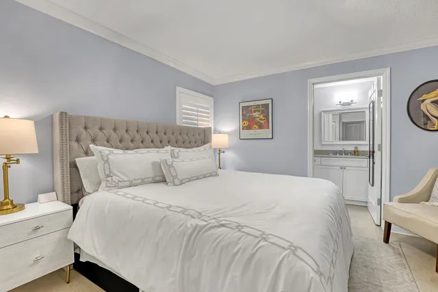 a bedroom with a bed and a view of living room