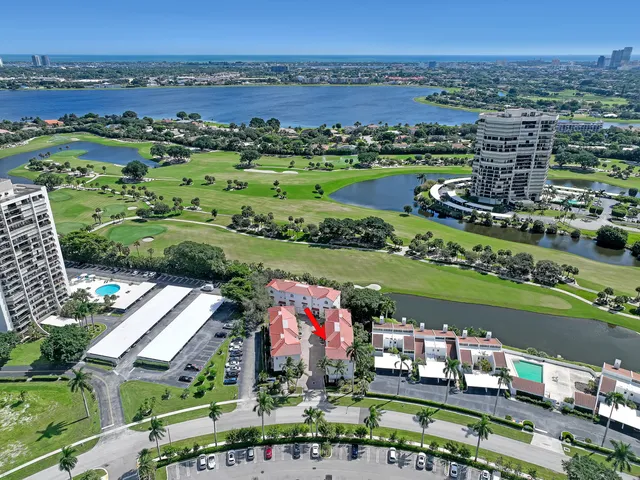 an aerial view of a city with lots of residential buildings and mountain view in back