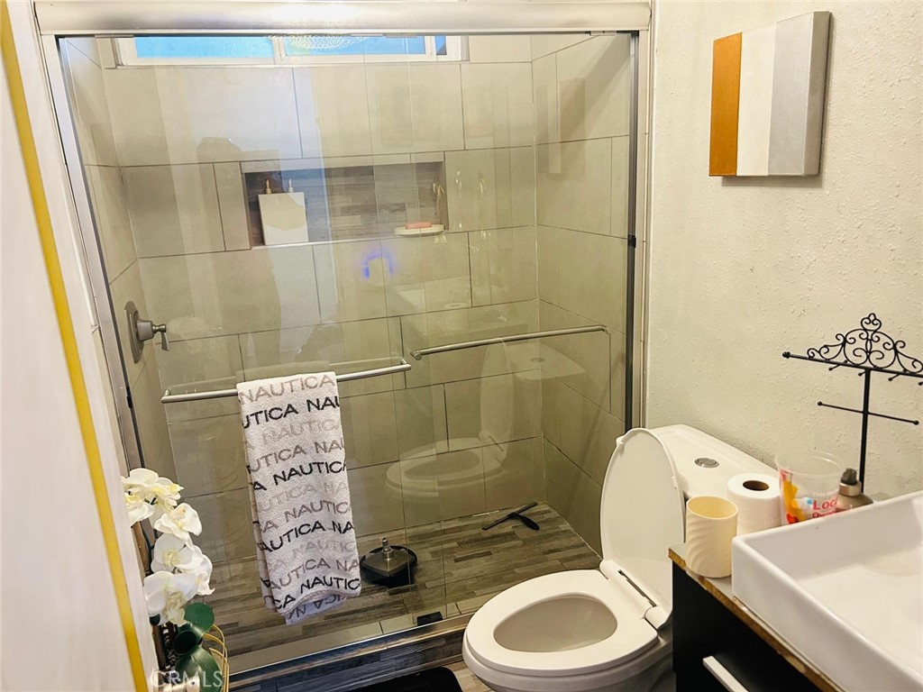 1025 South Riverside Avenue, Unit 26 Rialto, CA 92376 - Photo 11 of 20 a bathroom with a sink toilet and shower