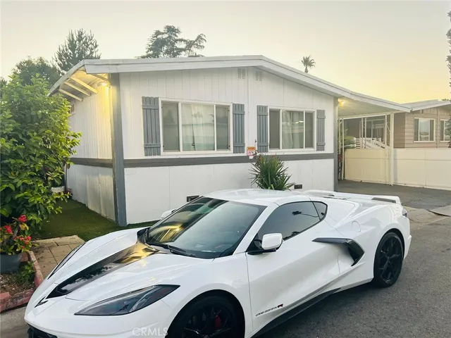 a view of a white car parked in front of house