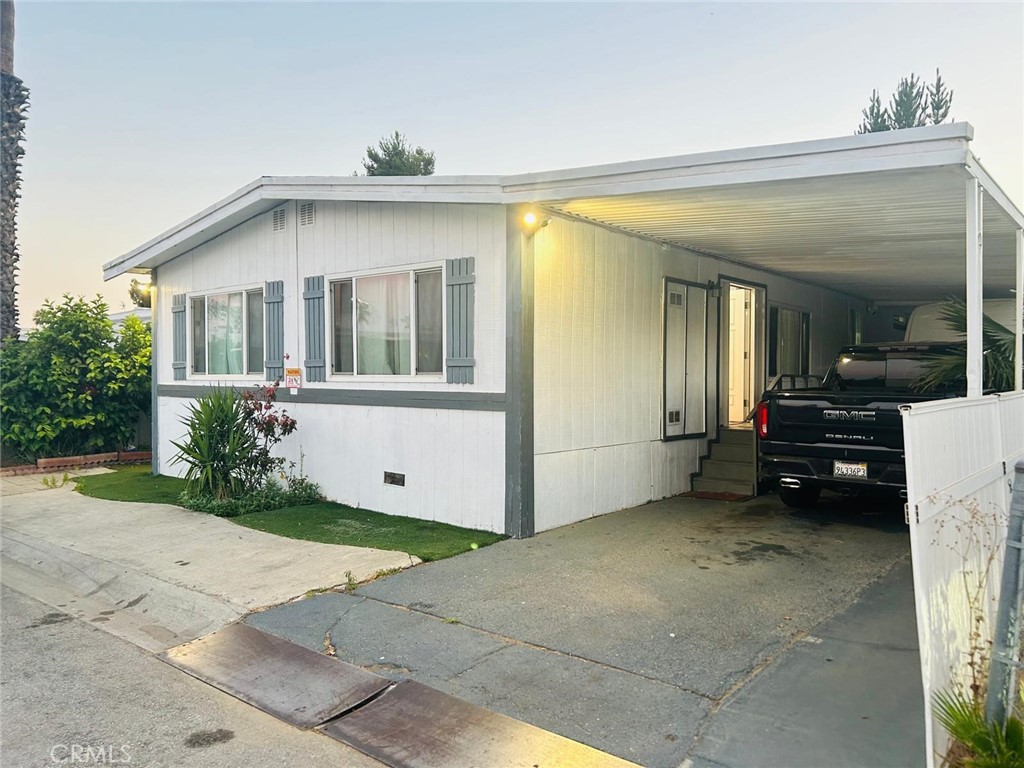 1025 South Riverside Avenue, Unit 26 Rialto, CA 92376 - Photo 17 of 20 a view of a house with a yard