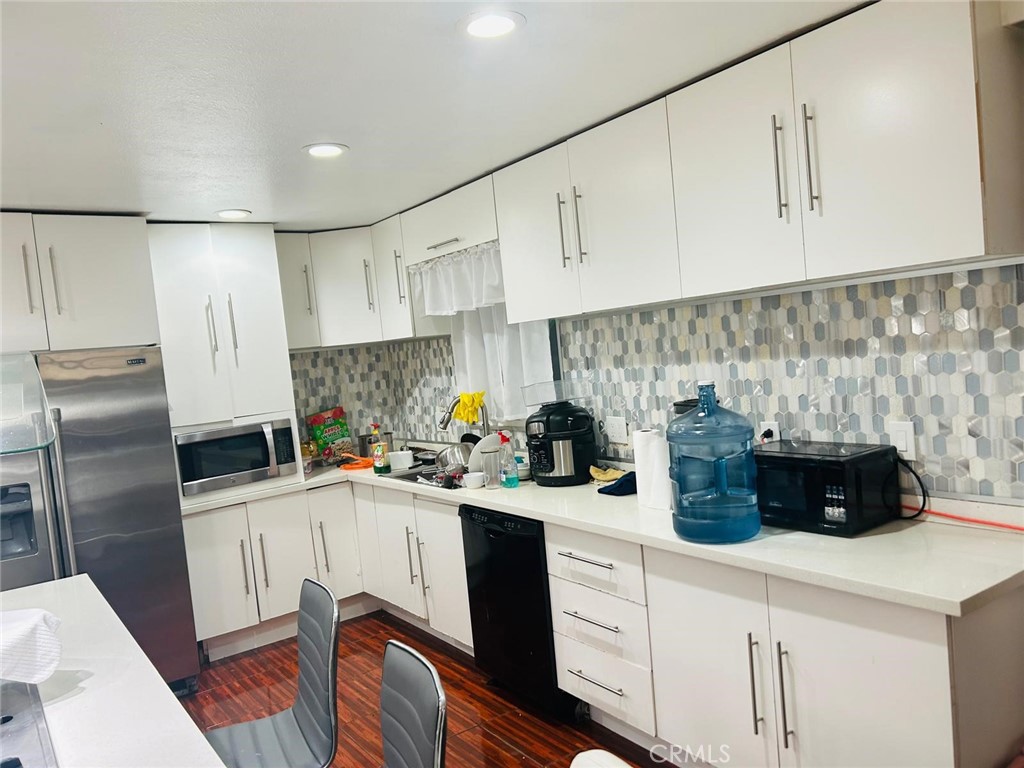 1025 South Riverside Avenue, Unit 26 Rialto, CA 92376 - Photo 2 of 20 a kitchen with a sink a refrigerator and cabinets