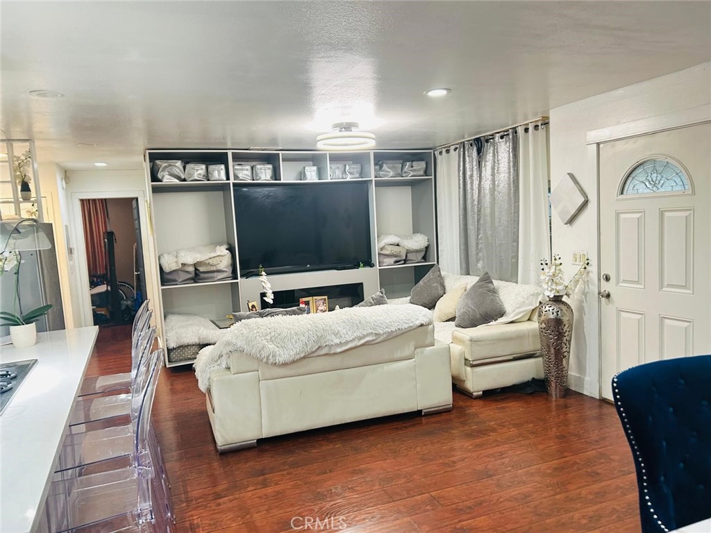 1025 South Riverside Avenue, Unit 26 Rialto, CA 92376 - Photo 4 of 20 a living room with furniture and a flat screen tv