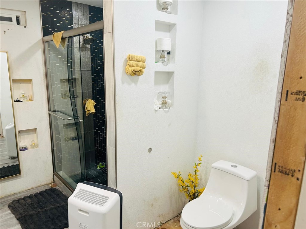 1025 South Riverside Avenue, Unit 26 Rialto, CA 92376 - Photo 6 of 20 a white toilet sitting next to a bathroom