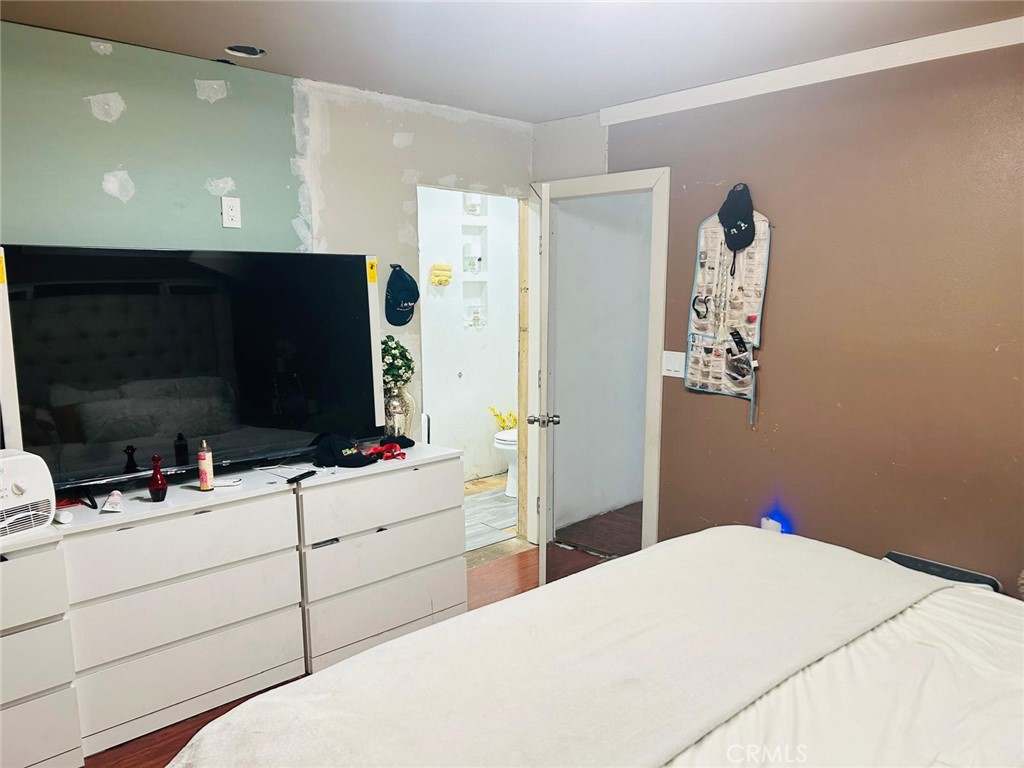 1025 South Riverside Avenue, Unit 26 Rialto, CA 92376 - Photo 7 of 20 a bedroom with a bed and a flat screen tv